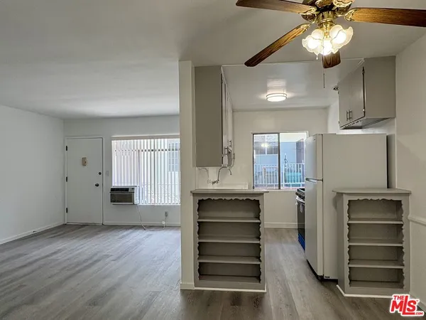 a view of a kitchen with wooden floor and staircase