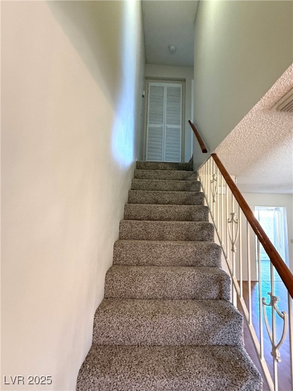 3367 Reka Street Las Vegas, NV 89121 - Photo 12 of 38 Staircase featuring a textured ceiling
