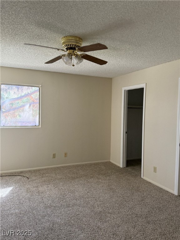 3367 Reka Street Las Vegas, NV 89121 - Photo 22 of 38 Unfurnished bedroom with a walk in closet, carpet floors, a textured ceiling, and a ceiling fan