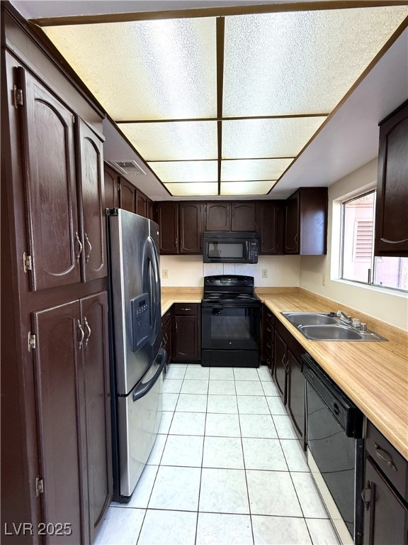 3367 Reka Street Las Vegas, NV 89121 - Photo 3 of 38 Kitchen featuring dark brown cabinets, light countertops, and black appliances
