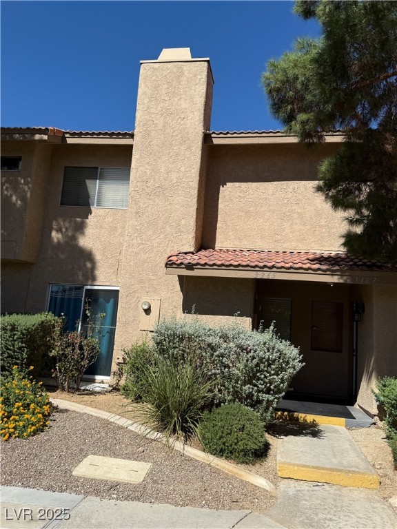 3367 Reka Street Las Vegas, NV 89121 - Photo 34 of 38 View of front of property with stucco siding, a tiled roof, and a chimney