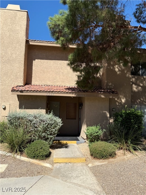 3367 Reka Street Las Vegas, NV 89121 - Photo 35 of 38 View of front facade featuring a tile roof and stucco siding