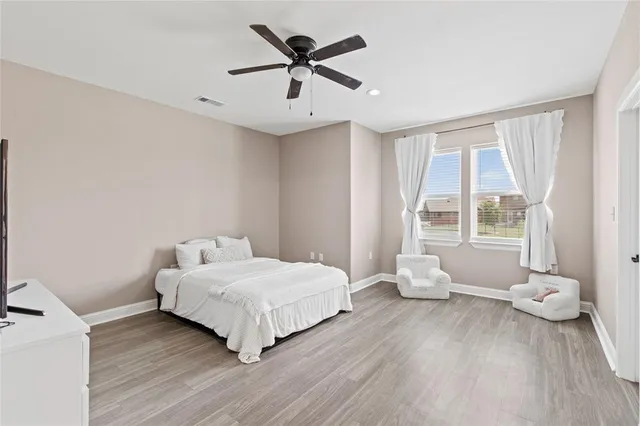 a bedroom with a bed and a large window