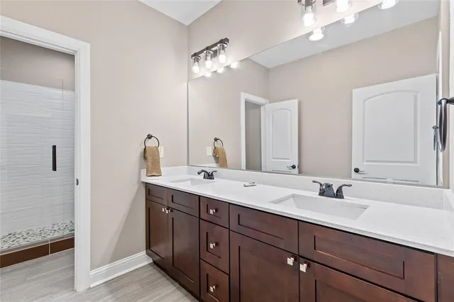 a bathroom with a double vanity sink and a mirror