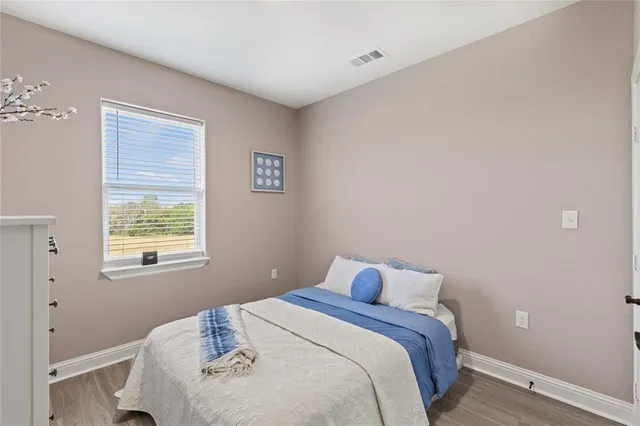 a bedroom with a bed and a window