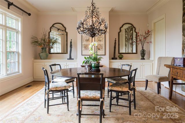 a view of a dining room with furniture and chandelier