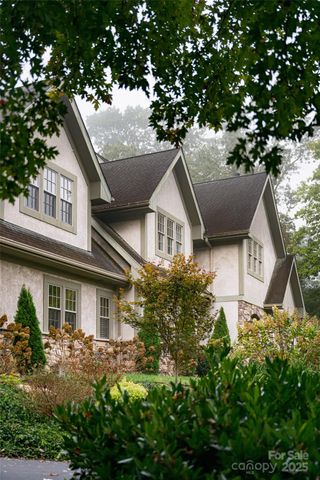 a front view of a house with a yard garage and outdoor seating
