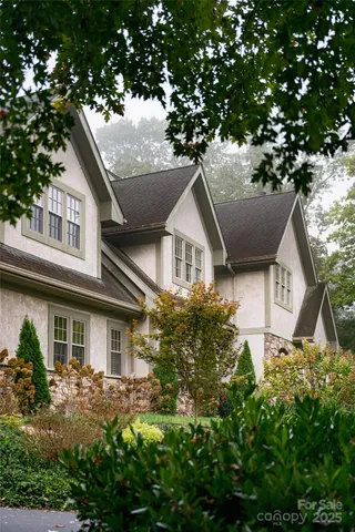 a front view of a house with a yard garage and outdoor seating