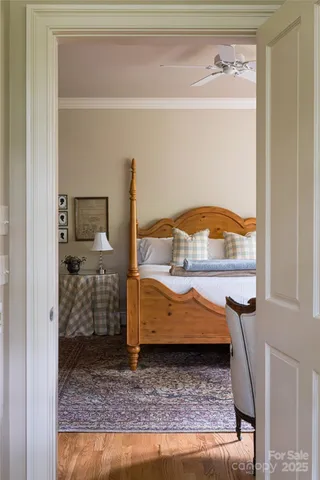 a bedroom with furniture and a large window