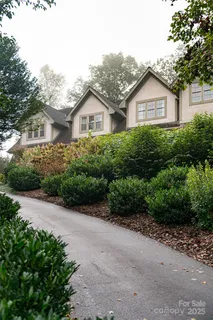 a front view of a house with a yard and a garage
