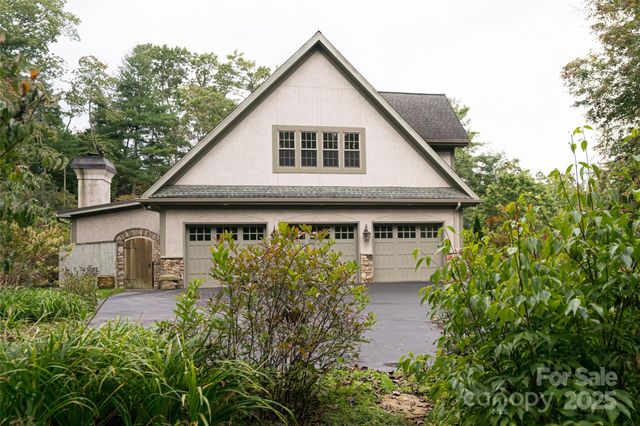 a front view of a house with plants