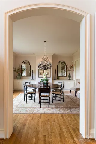 a view of a dining room with furniture and chandelier