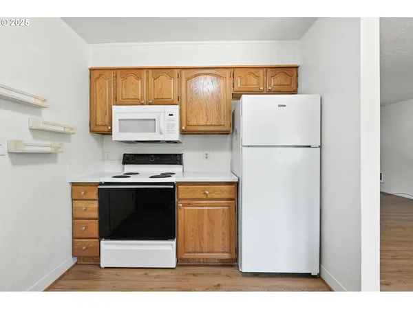 a white refrigerator freezer sitting in a kitchen