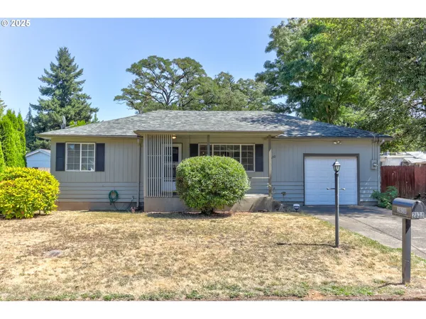 a view of a house with a yard and garage