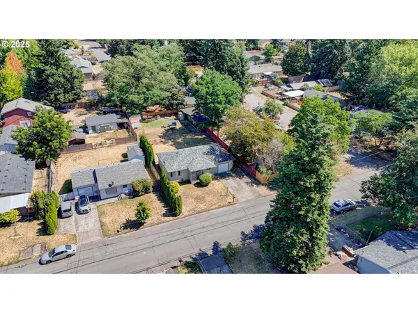 an aerial view of a house with a yard