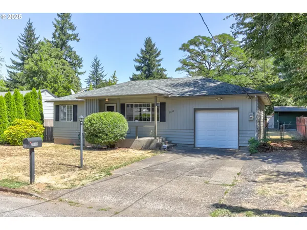 a view of a house with a yard and potted plants
