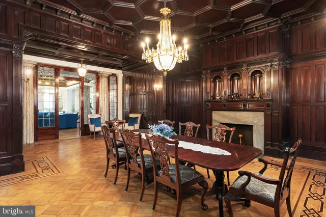 a room with painting on the wall and a wooden floor