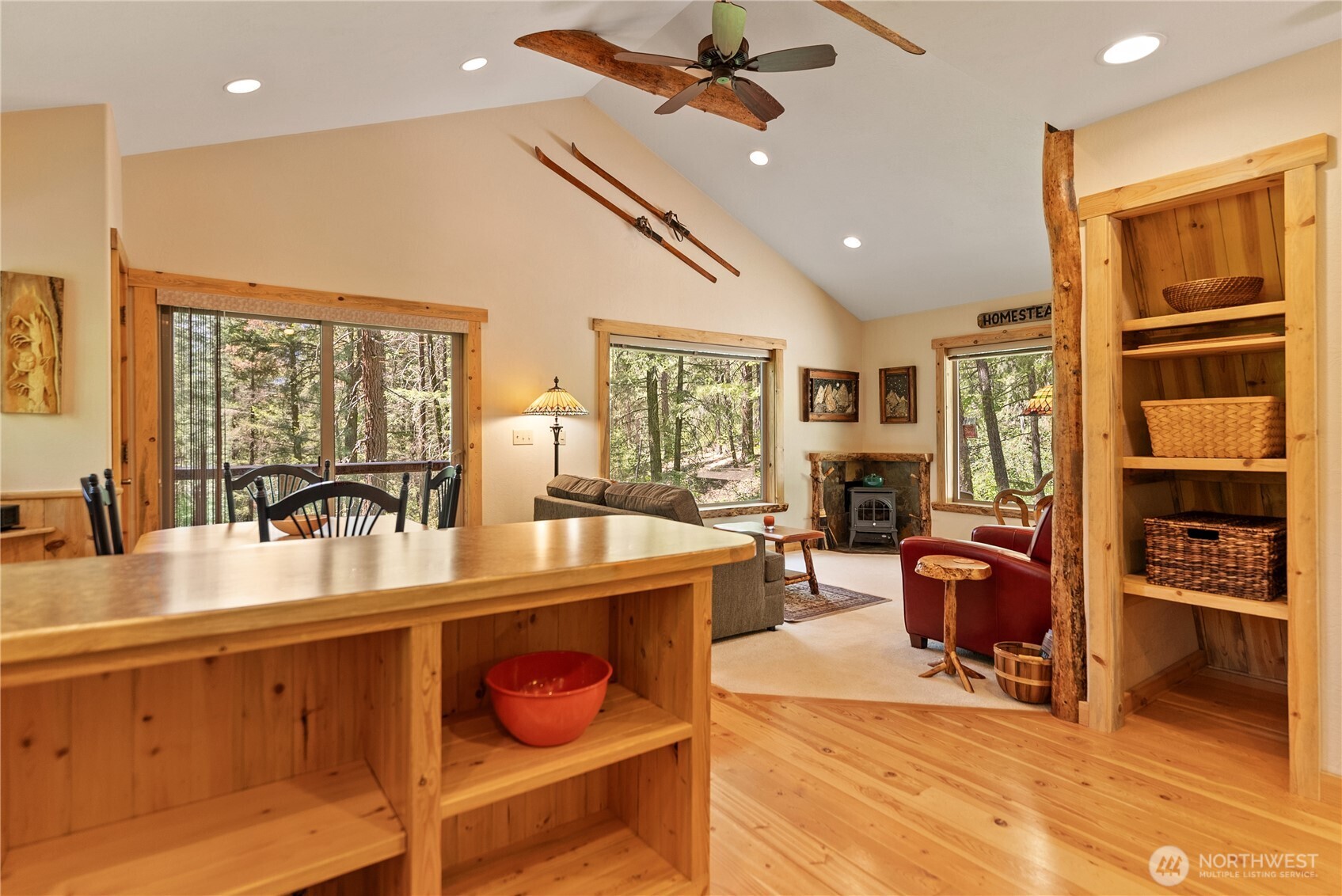98 Homestead Road Winthrop, WA 98862 - Photo 11 of 40 a dining hall with stainless steel appliances granite countertop a stove a sink dishwasher a dining table and chairs with wooden floor
