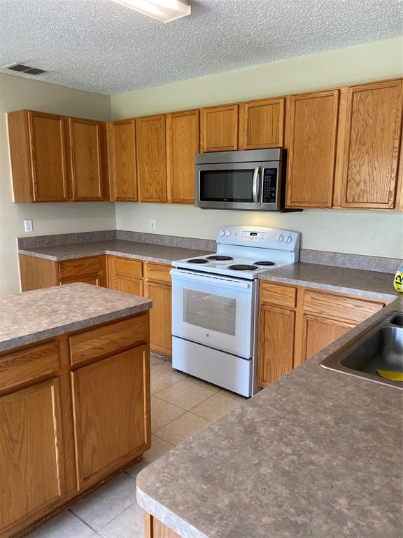 1416 Laurel Hall Lane Little Elm, TX 75068 - Photo 7 of 24 VIEW OF KITCHEN FROM BREASKFAST BAR