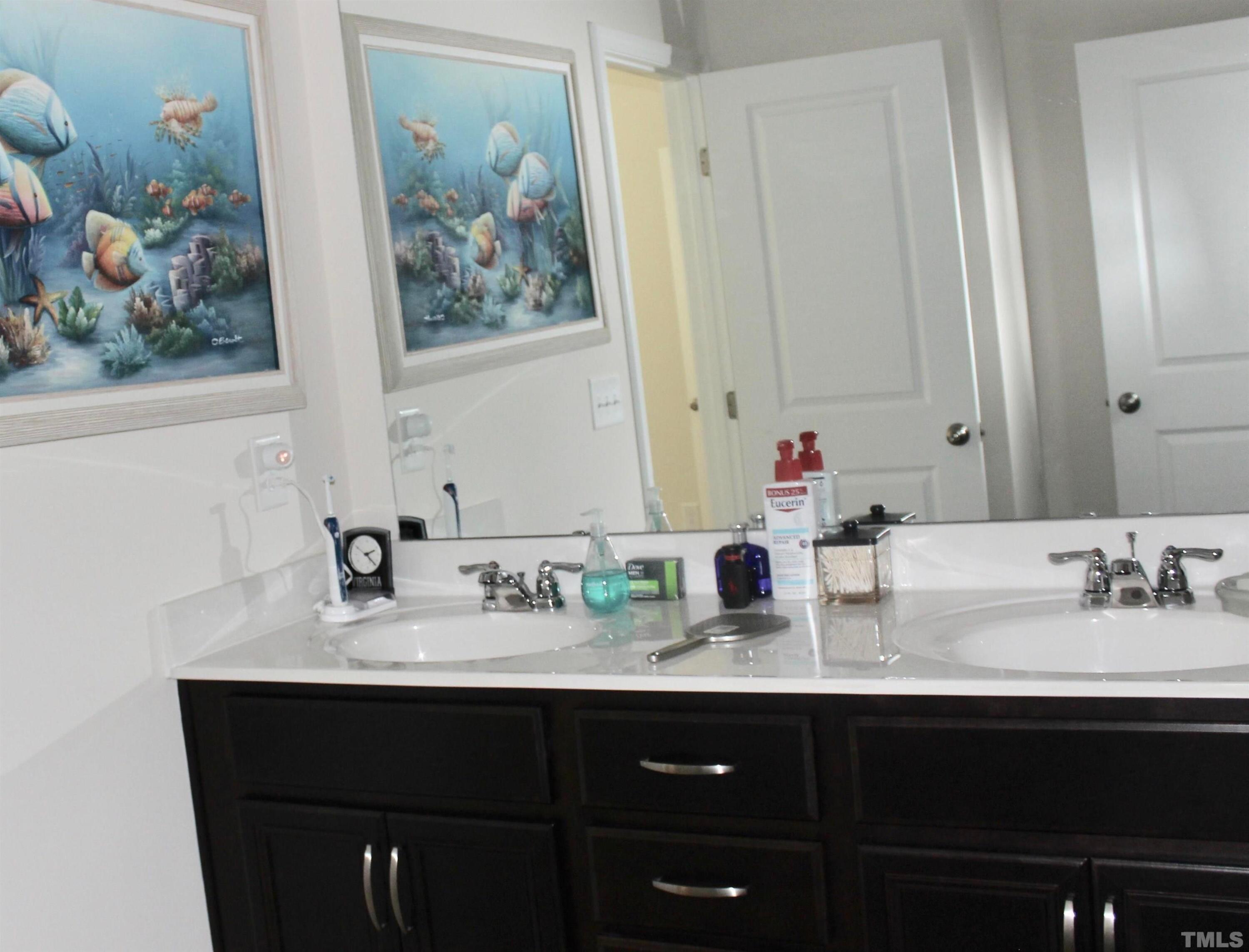 1608 Topaz Lane Apex, NC 27502 - Photo 14 of 23 a bathroom with a sink and a mirror