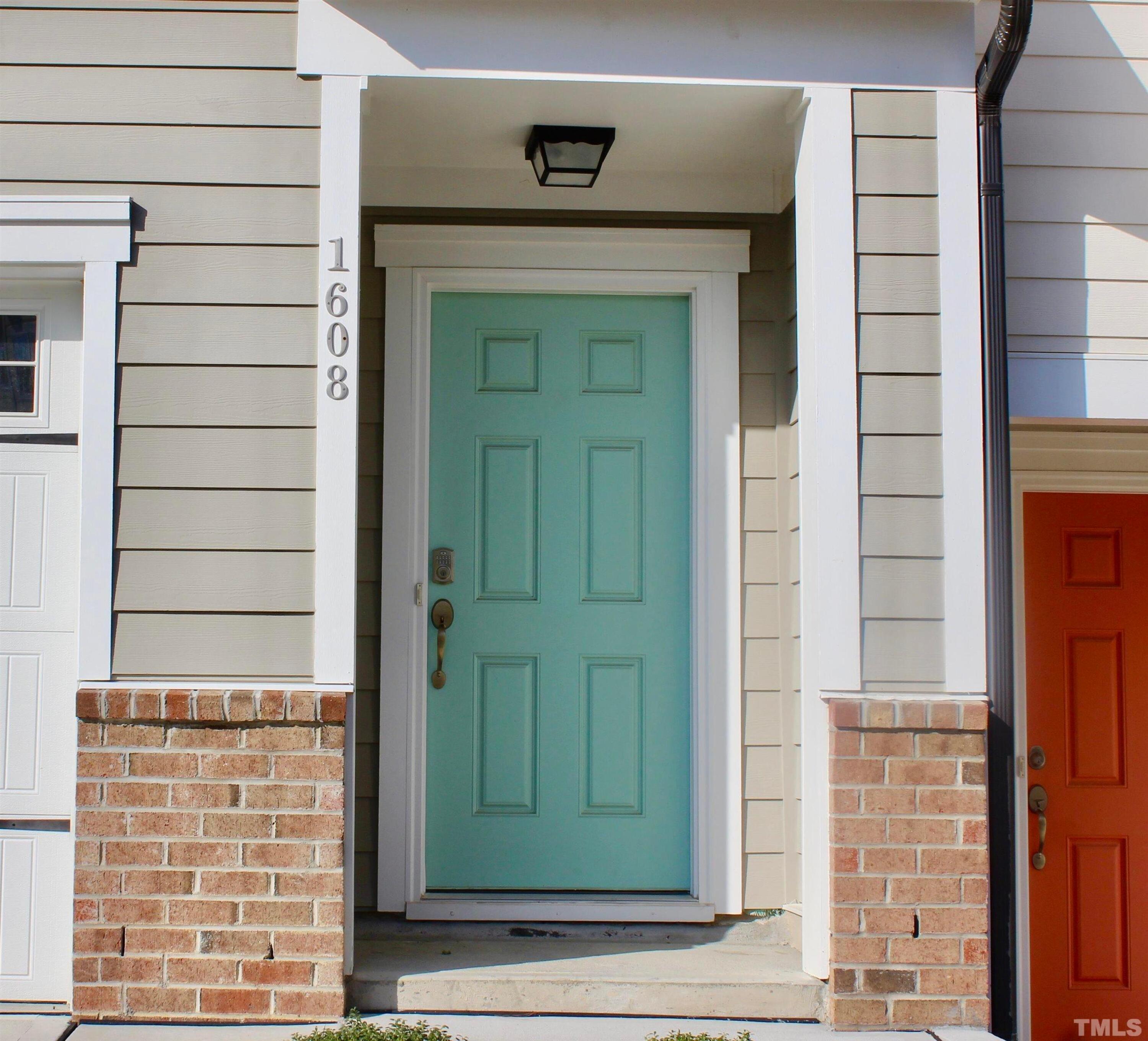 1608 Topaz Lane Apex, NC 27502 - Photo 2 of 23 a front view of a house with a shower and a door