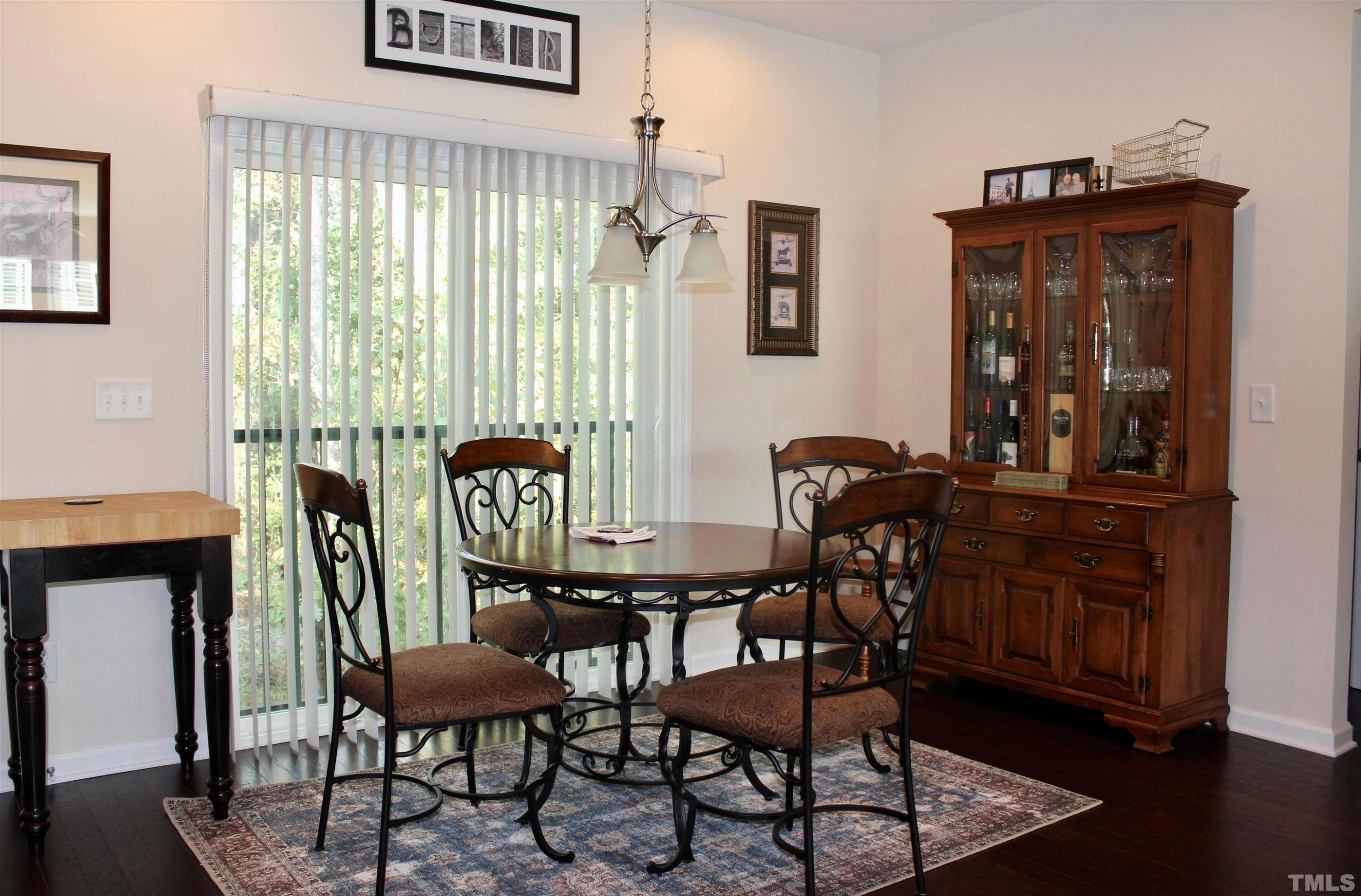 1608 Topaz Lane Apex, NC 27502 - Photo 7 of 23 a view of a dining room with furniture and wooden floor