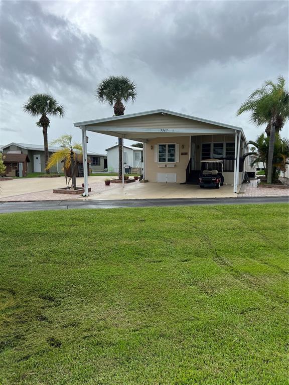 a view of a house with a yard porch and sitting area