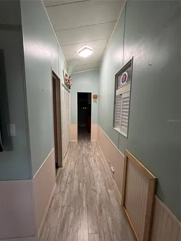 a view of hallway with wooden floor