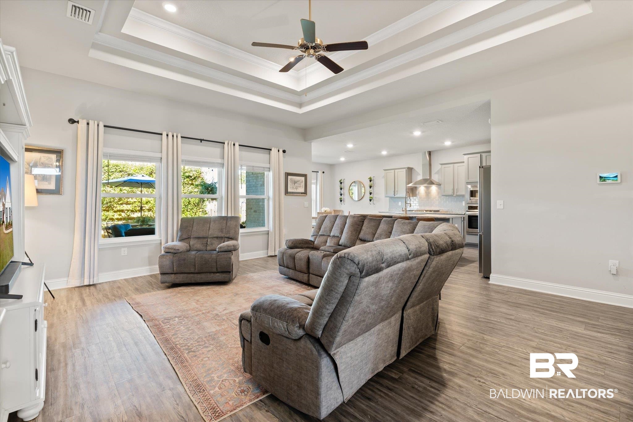 12899 Sanderling Loop Daphne, AL 36527 - Photo 6 of 28 Living room with ornamental molding, hardwood / wood-style floors, ceiling fan, and a raised ceiling