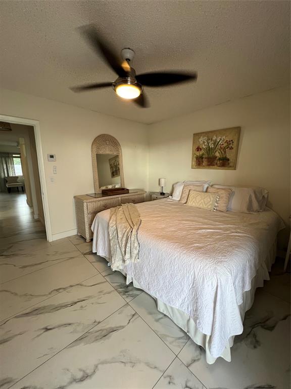 900 Southwest 10th Terrace, Unit S20 Hallandale Beach, FL 33009 - Photo 15 of 20 a bedroom with a bed and a mirror
