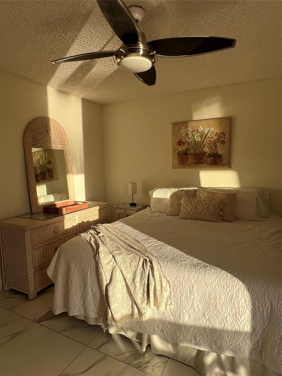 900 Southwest 10th Terrace, Unit S20 Hallandale Beach, FL 33009 - Photo 16 of 20 a bedroom with a bed and a mirror