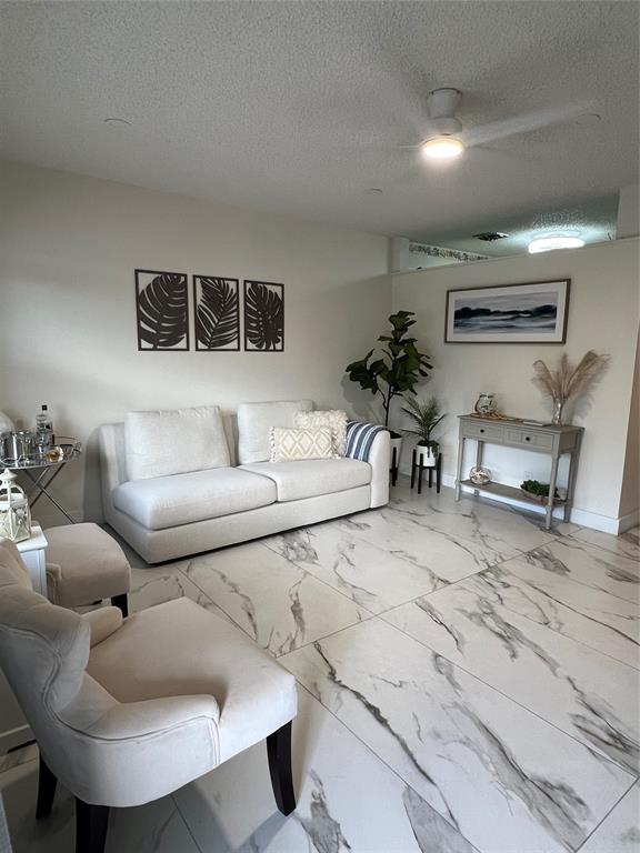 900 Southwest 10th Terrace, Unit S20 Hallandale Beach, FL 33009 - Photo 2 of 20 a living room with furniture and a table