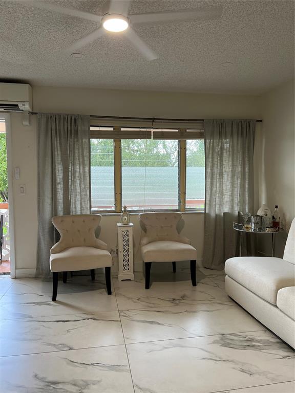 900 Southwest 10th Terrace, Unit S20 Hallandale Beach, FL 33009 - Photo 4 of 20 a living room with furniture and a large window