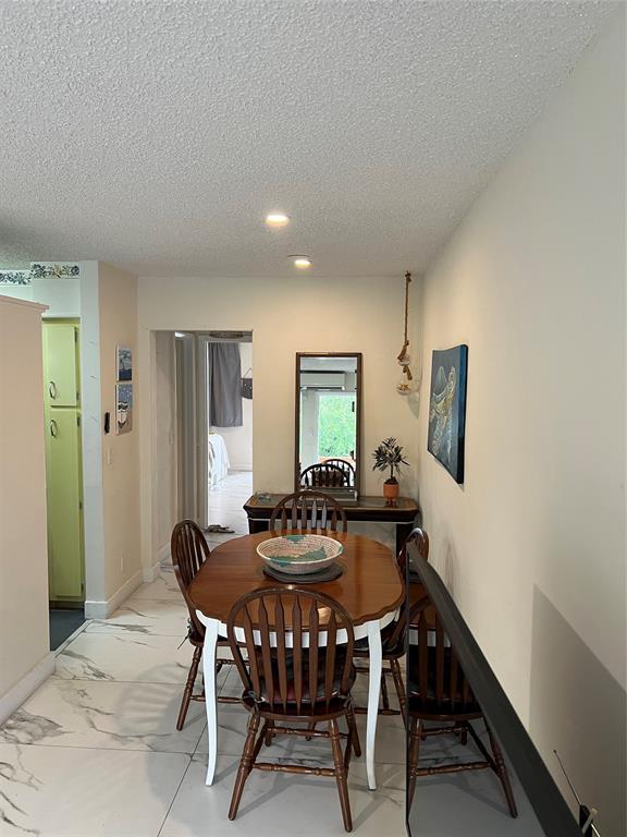900 Southwest 10th Terrace, Unit S20 Hallandale Beach, FL 33009 - Photo 10 of 20 a view of a dining room with furniture and window