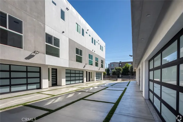 a balcony with a couch and large windows