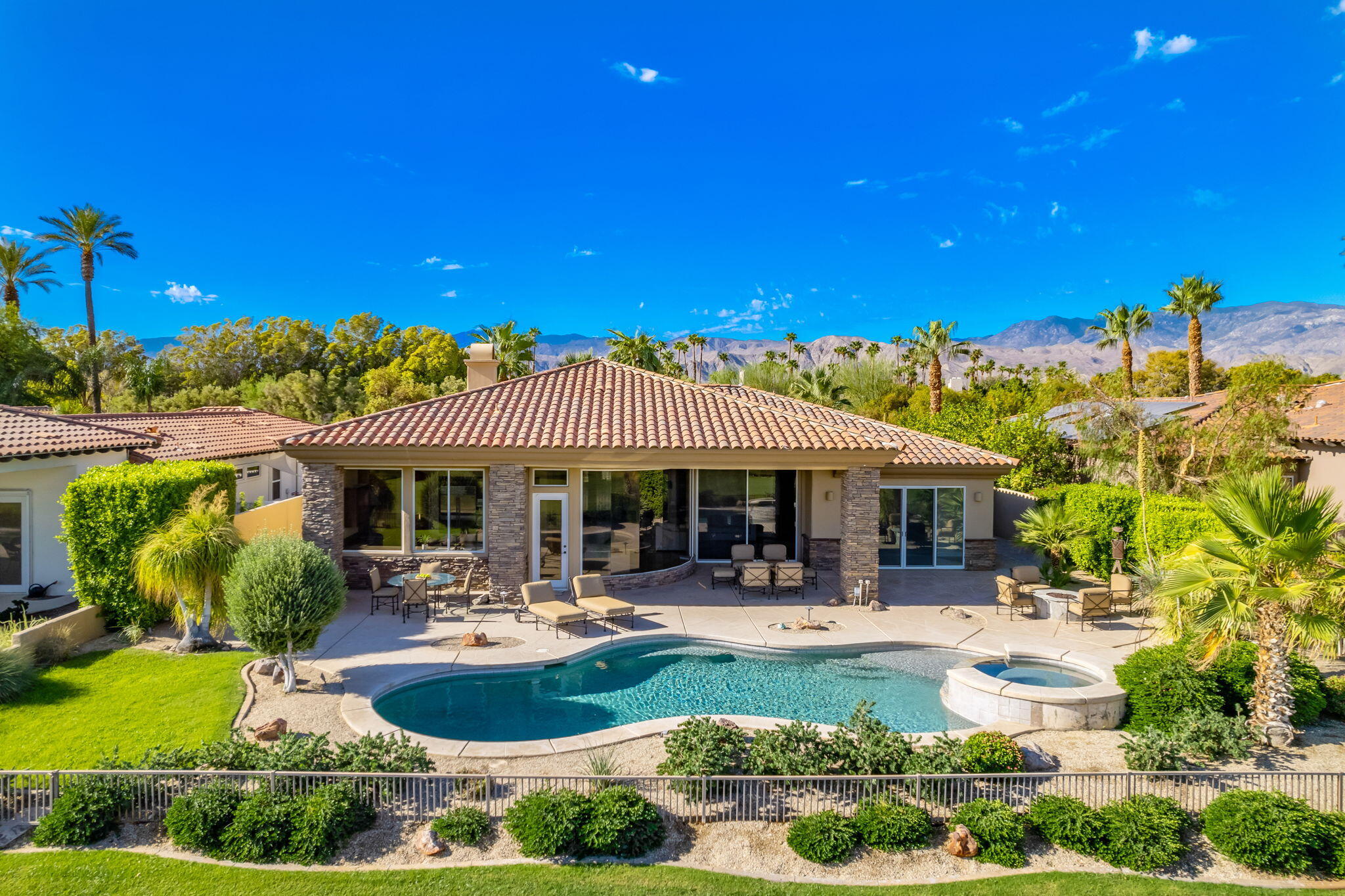 142 Loch Lomond Road Rancho Mirage, CA 92270 - Photo 1 of 62 a swimming pool with outdoor seating and yard