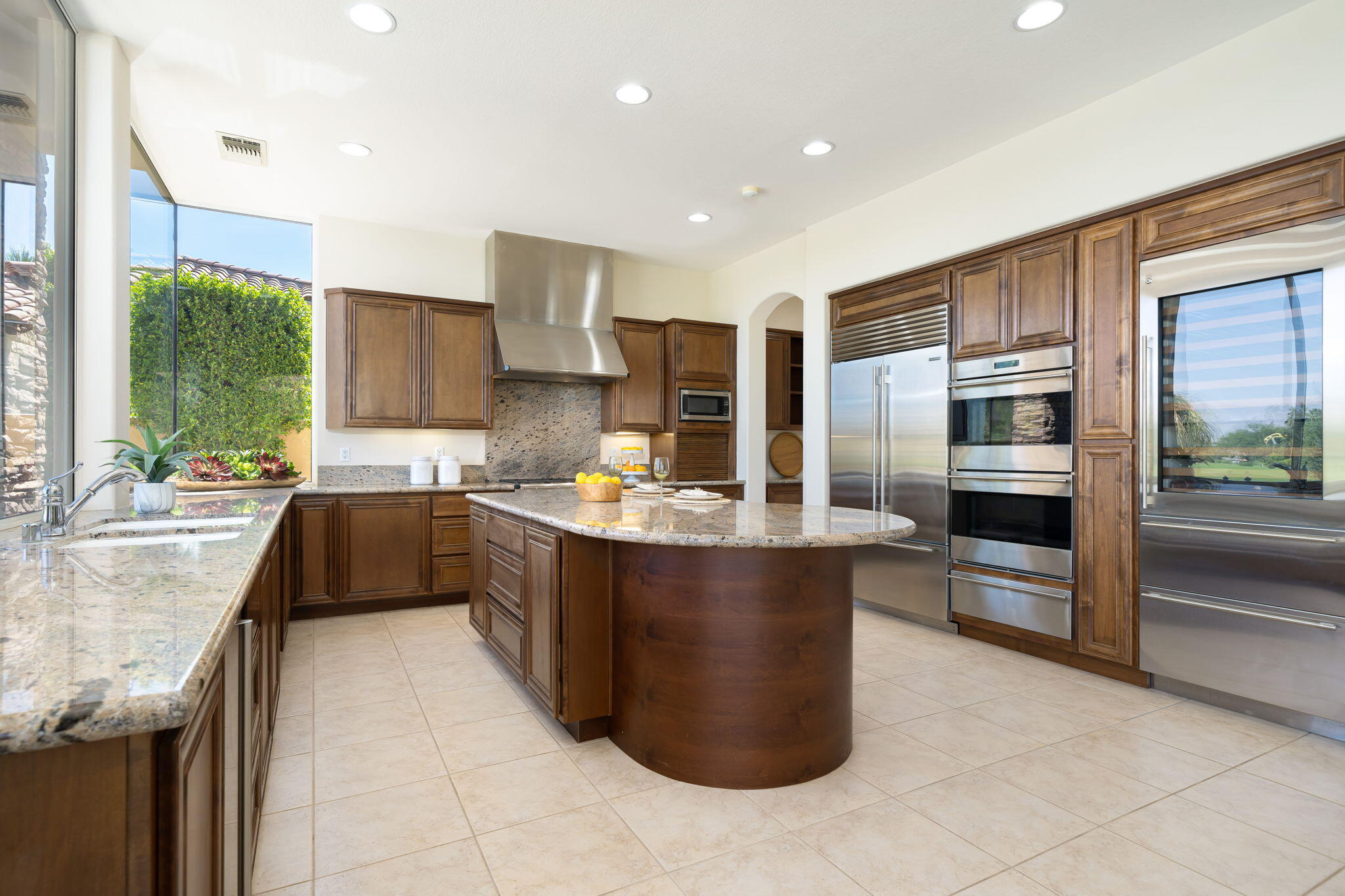 142 Loch Lomond Road Rancho Mirage, CA 92270 - Photo 15 of 62 a kitchen with stainless steel appliances granite countertop a stove a sink and a refrigerator
