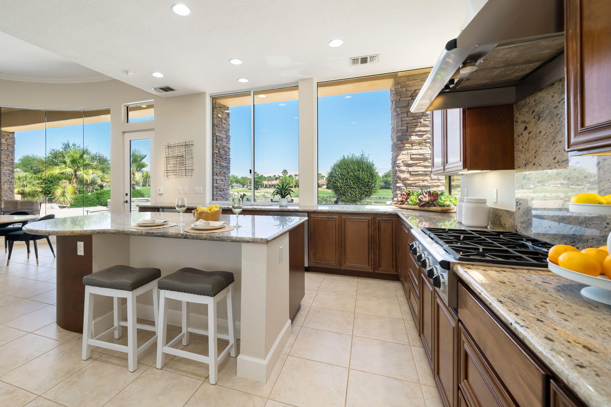 142 Loch Lomond Road Rancho Mirage, CA 92270 - Photo 16 of 62 a kitchen with a stove a sink and a dining table