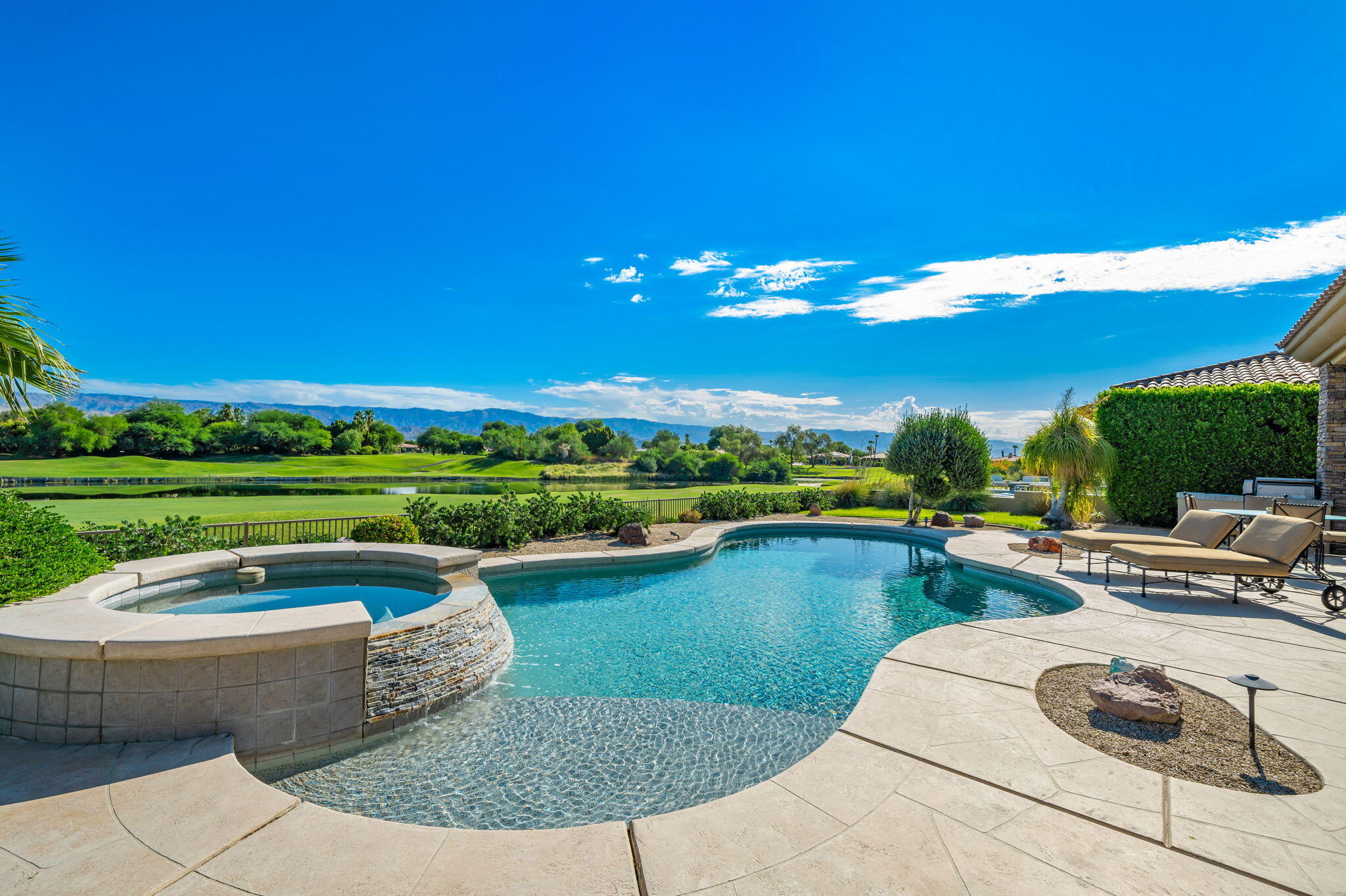 142 Loch Lomond Road Rancho Mirage, CA 92270 - Photo 2 of 62 a view of a swimming pool and lounge chair