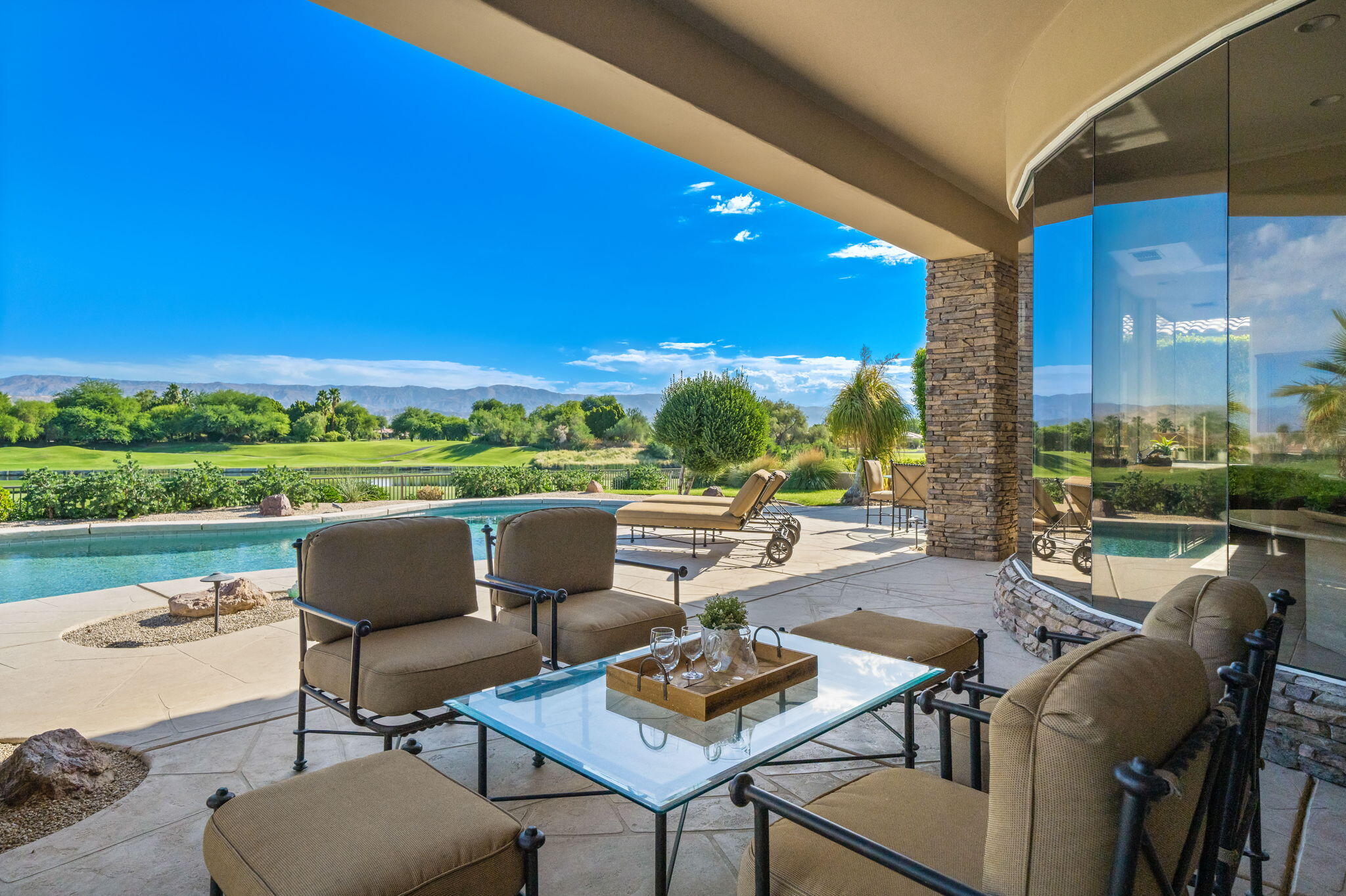 142 Loch Lomond Road Rancho Mirage, CA 92270 - Photo 27 of 62 a view of a patio with lawn chairs next to a yard