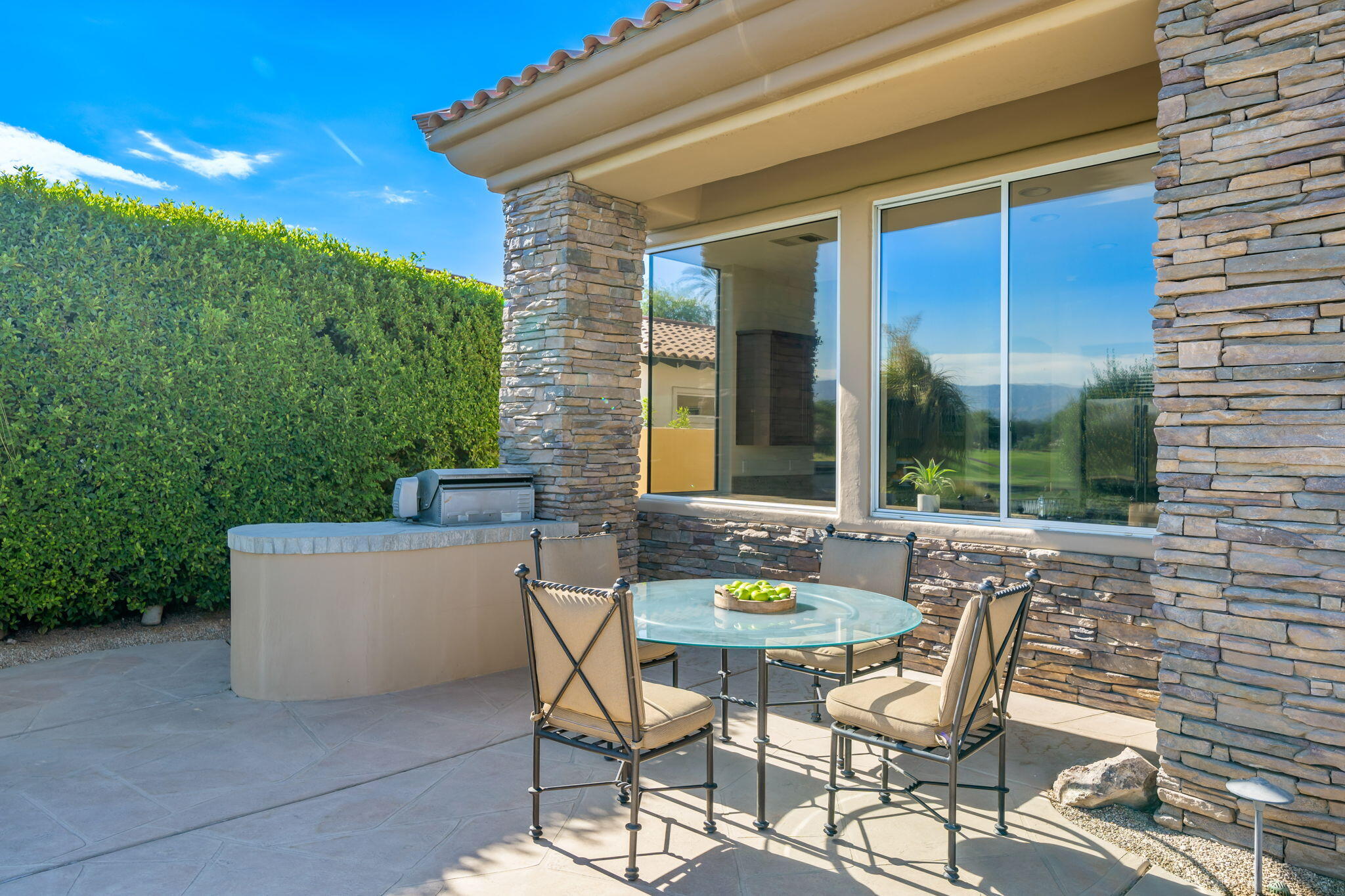 142 Loch Lomond Road Rancho Mirage, CA 92270 - Photo 29 of 62 a view of a patio with a table and chairs and potted plants