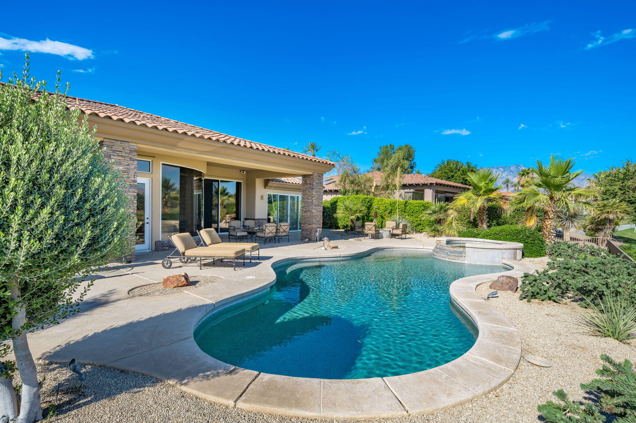 142 Loch Lomond Road Rancho Mirage, CA 92270 - Photo 31 of 62 a view of a swimming pool with outdoor seating