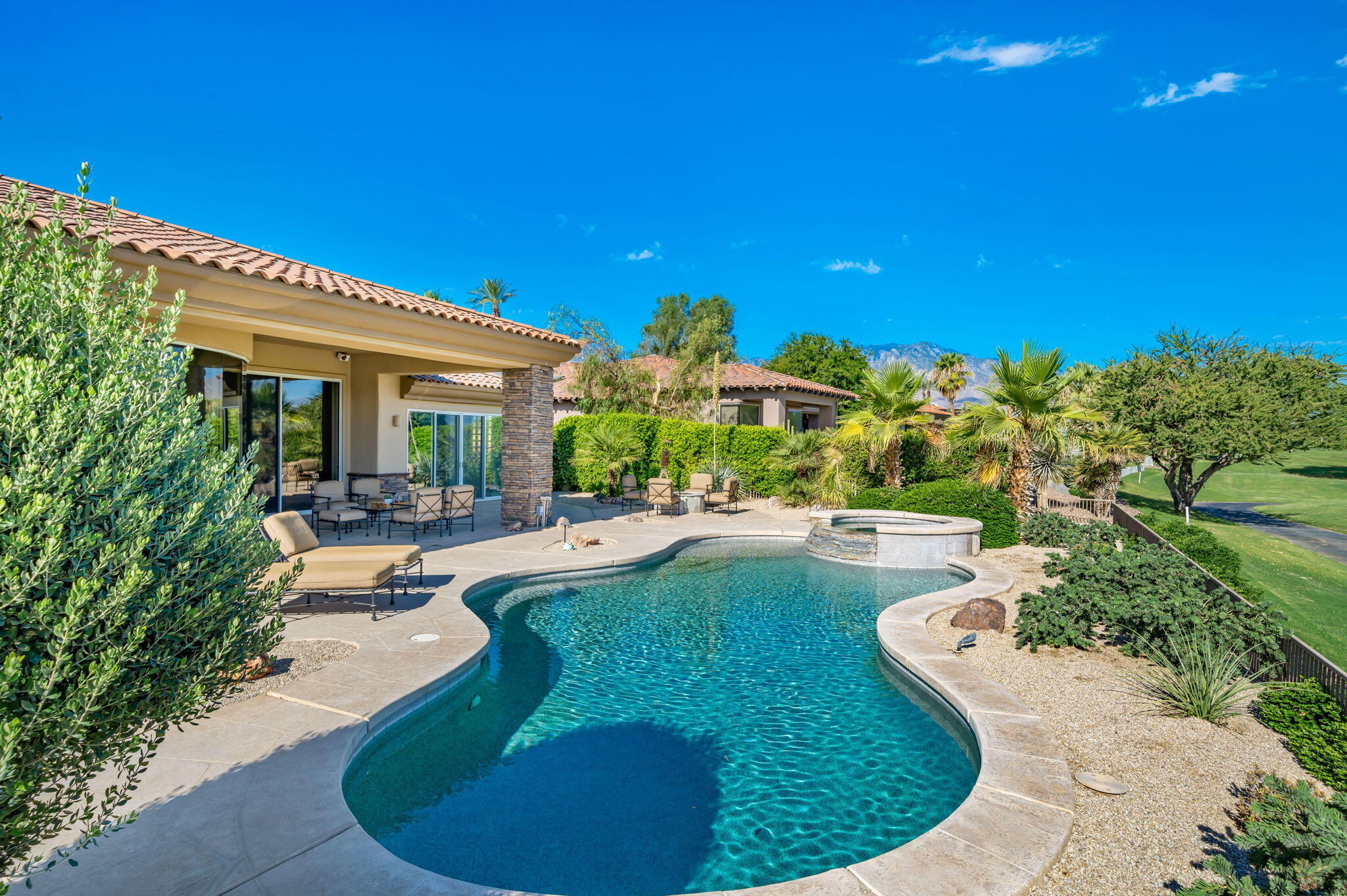 142 Loch Lomond Road Rancho Mirage, CA 92270 - Photo 33 of 62 a view of a swimming pool with a patio