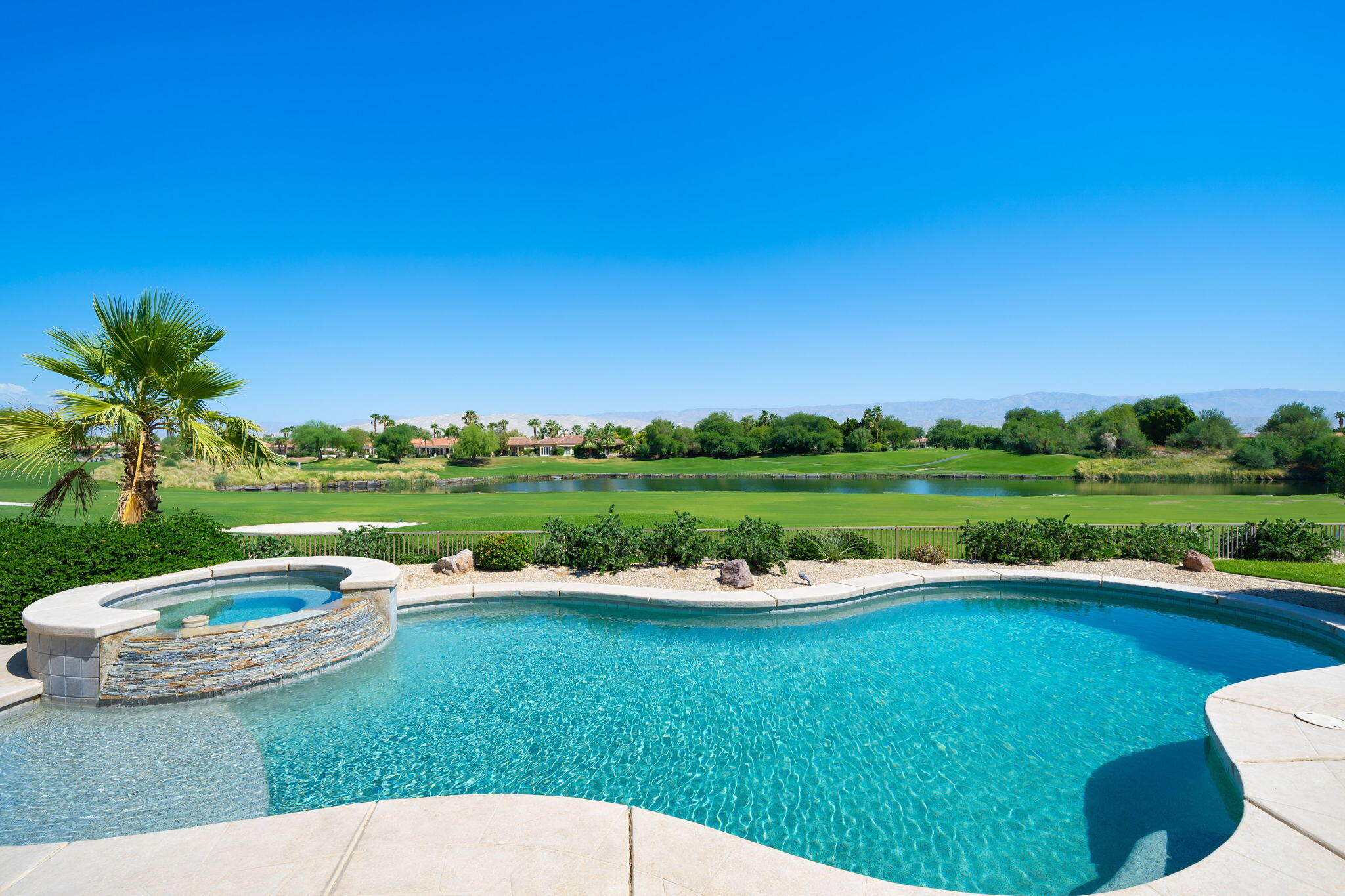 142 Loch Lomond Road Rancho Mirage, CA 92270 - Photo 37 of 62 a view of a lake with a yard and green space