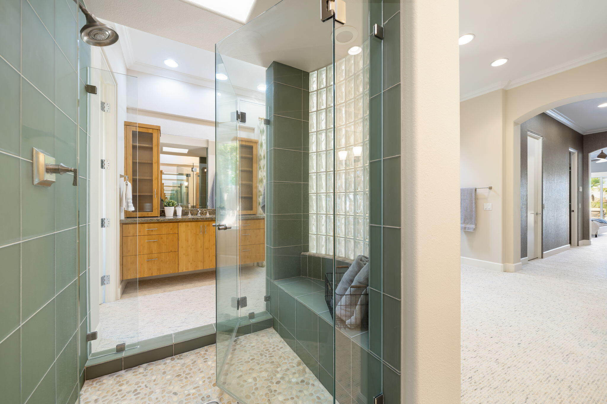 142 Loch Lomond Road Rancho Mirage, CA 92270 - Photo 46 of 62 a bathroom with a glass shower door a sink and a mirror