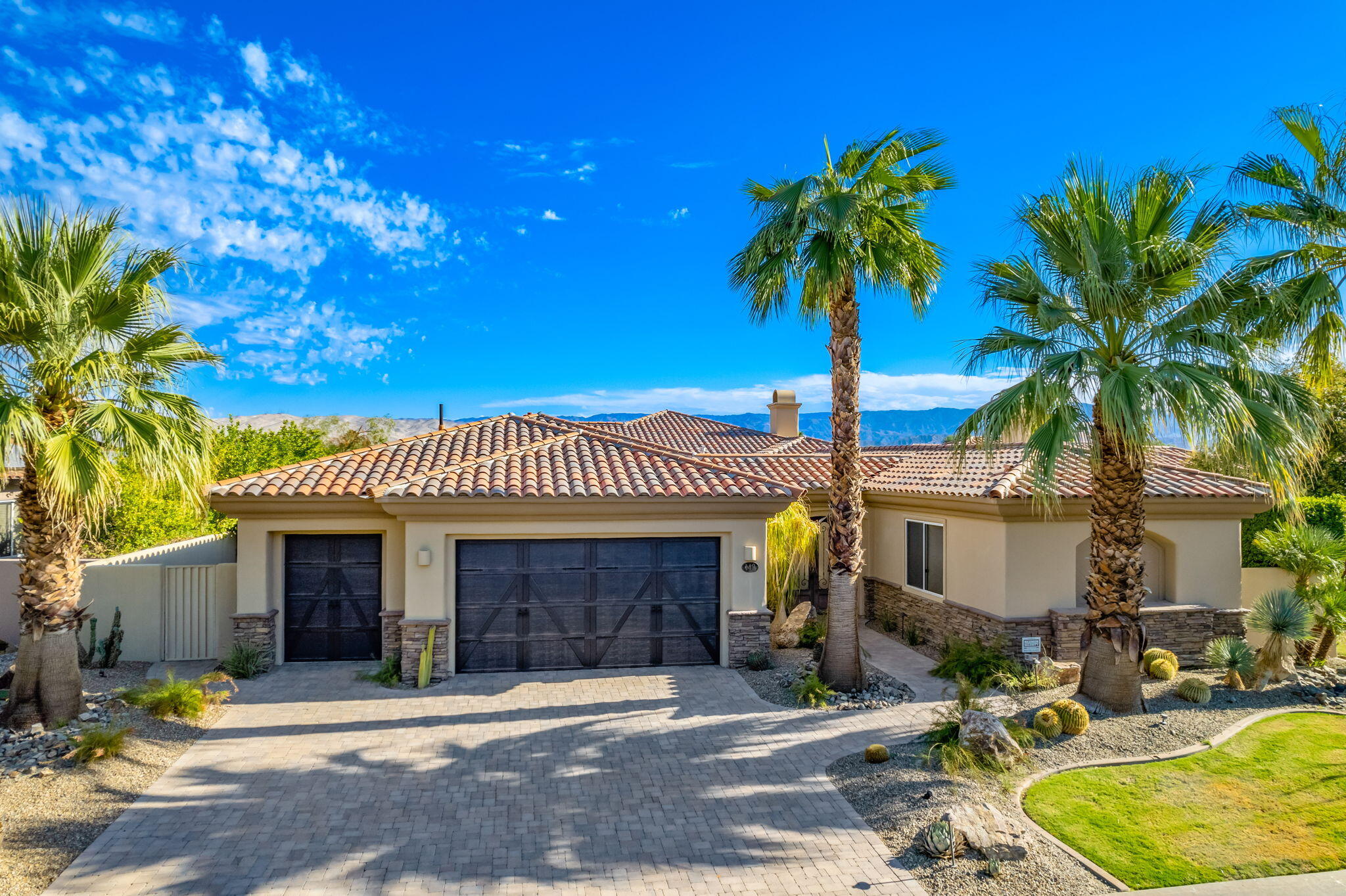 142 Loch Lomond Road Rancho Mirage, CA 92270 - Photo 5 of 62 a front view of a house with garden and parking