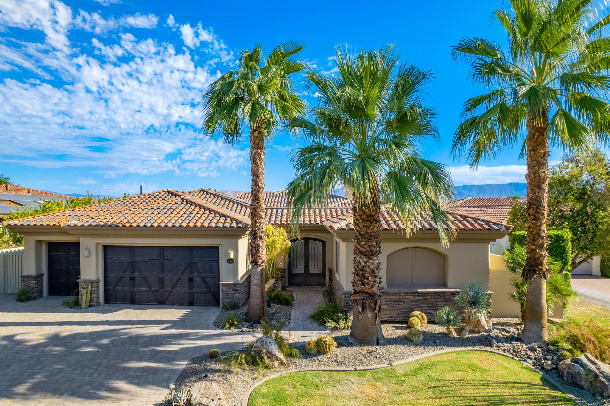 142 Loch Lomond Road Rancho Mirage, CA 92270 - Photo 6 of 62 a front view of a house with patio