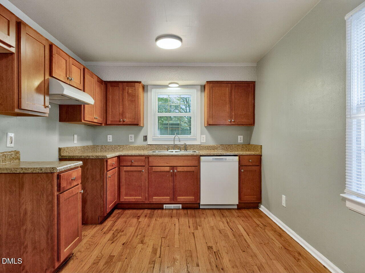 2811 Club Plaza Road Raleigh, NC 27603 - Photo 13 of 38 a kitchen with granite countertop wooden cabinets a sink and dishwasher