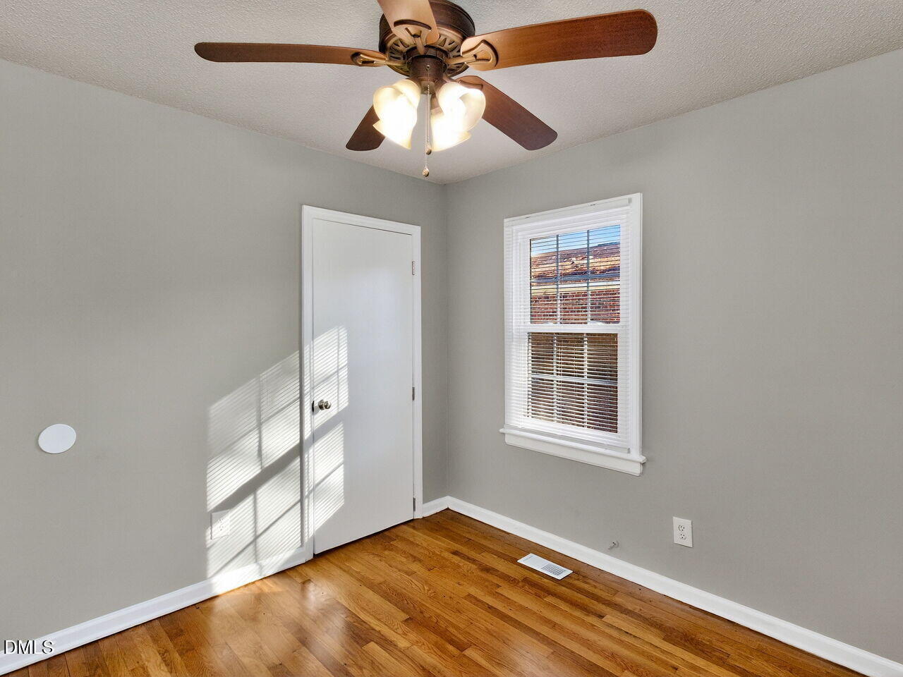 2811 Club Plaza Road Raleigh, NC 27603 - Photo 21 of 38 a view of an empty room with a window and wooden floor