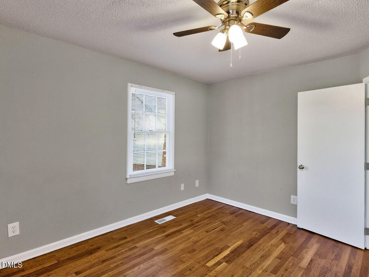 2811 Club Plaza Road Raleigh, NC 27603 - Photo 28 of 38 a view of an empty room with wooden floor and a window